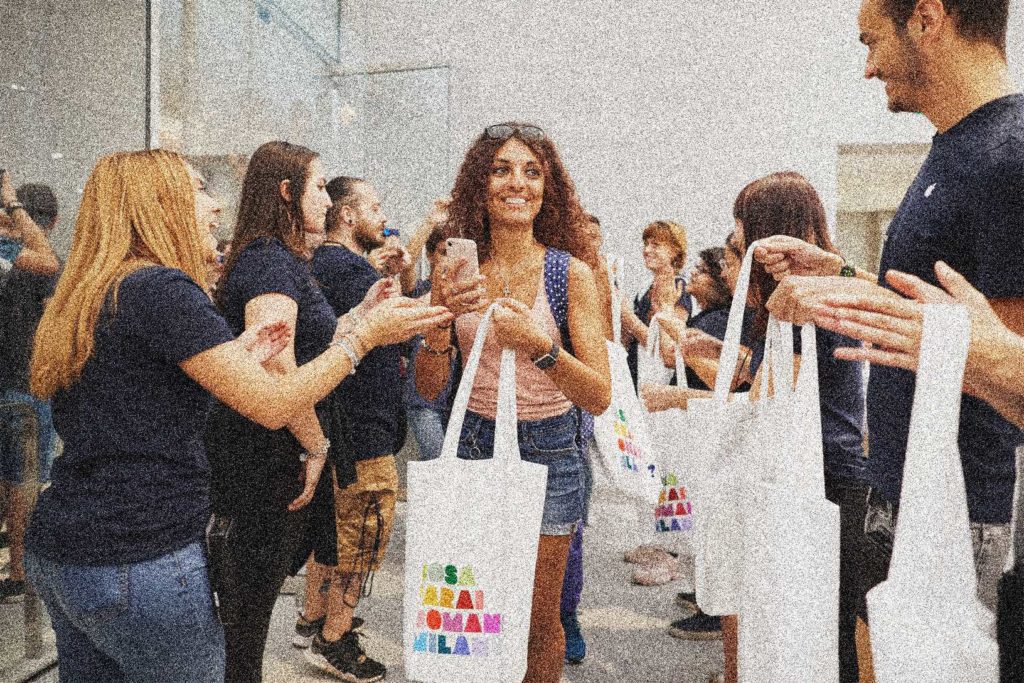 A female customer carries an Apple shopping bag at an Apple retail